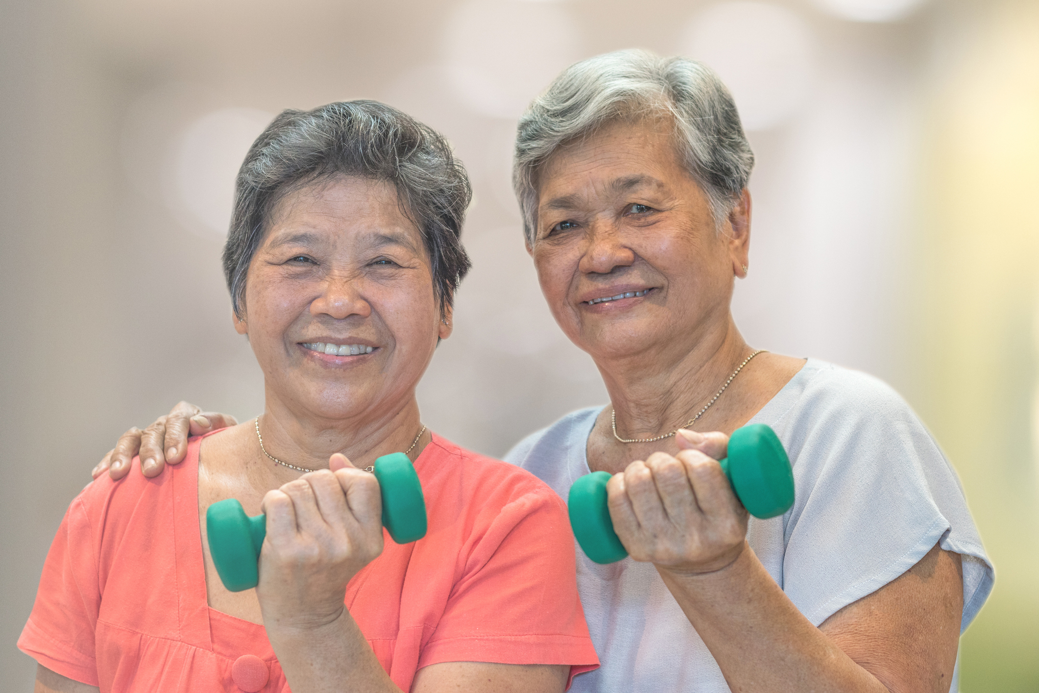 Senior elderly Asia woman hand holding dumbbell in physical therapy session. Healthy old people concept.