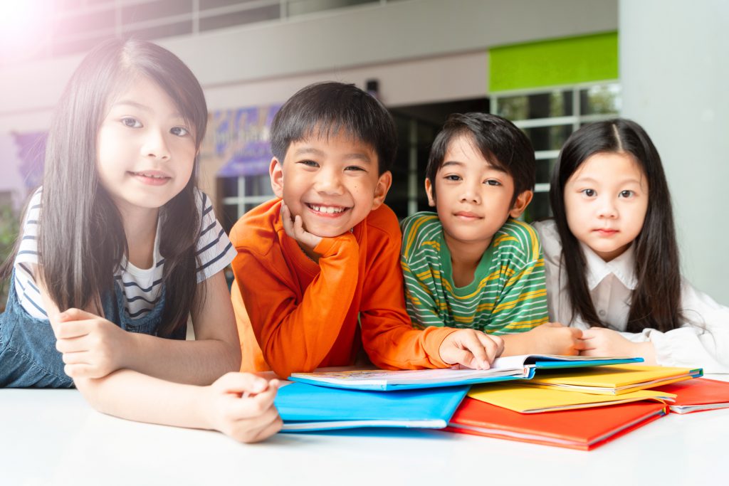 Asian Little Children Reading Book Cheerful