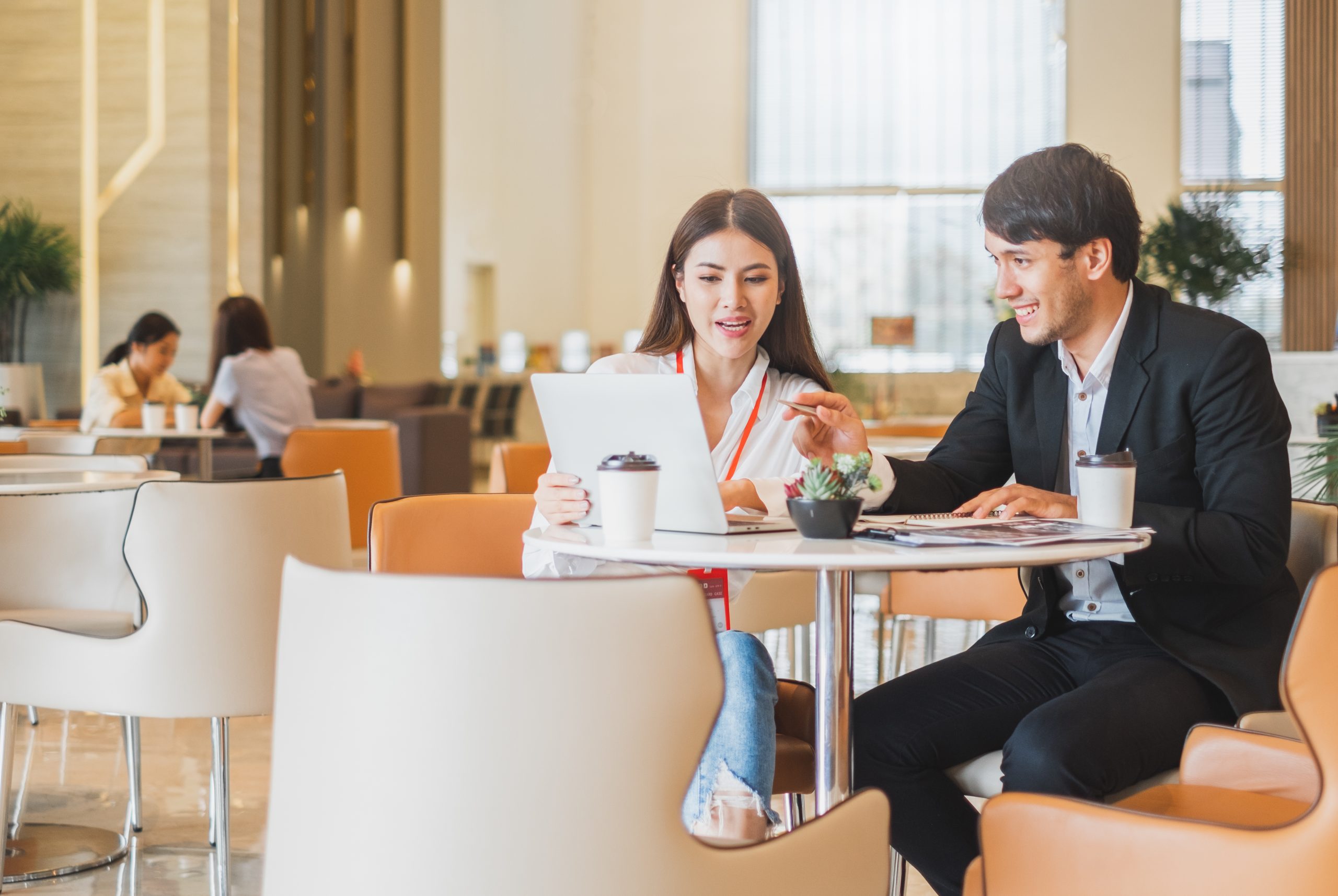 Young Asian business people and salesman broker discussing about insurance and financial investment planning in working office