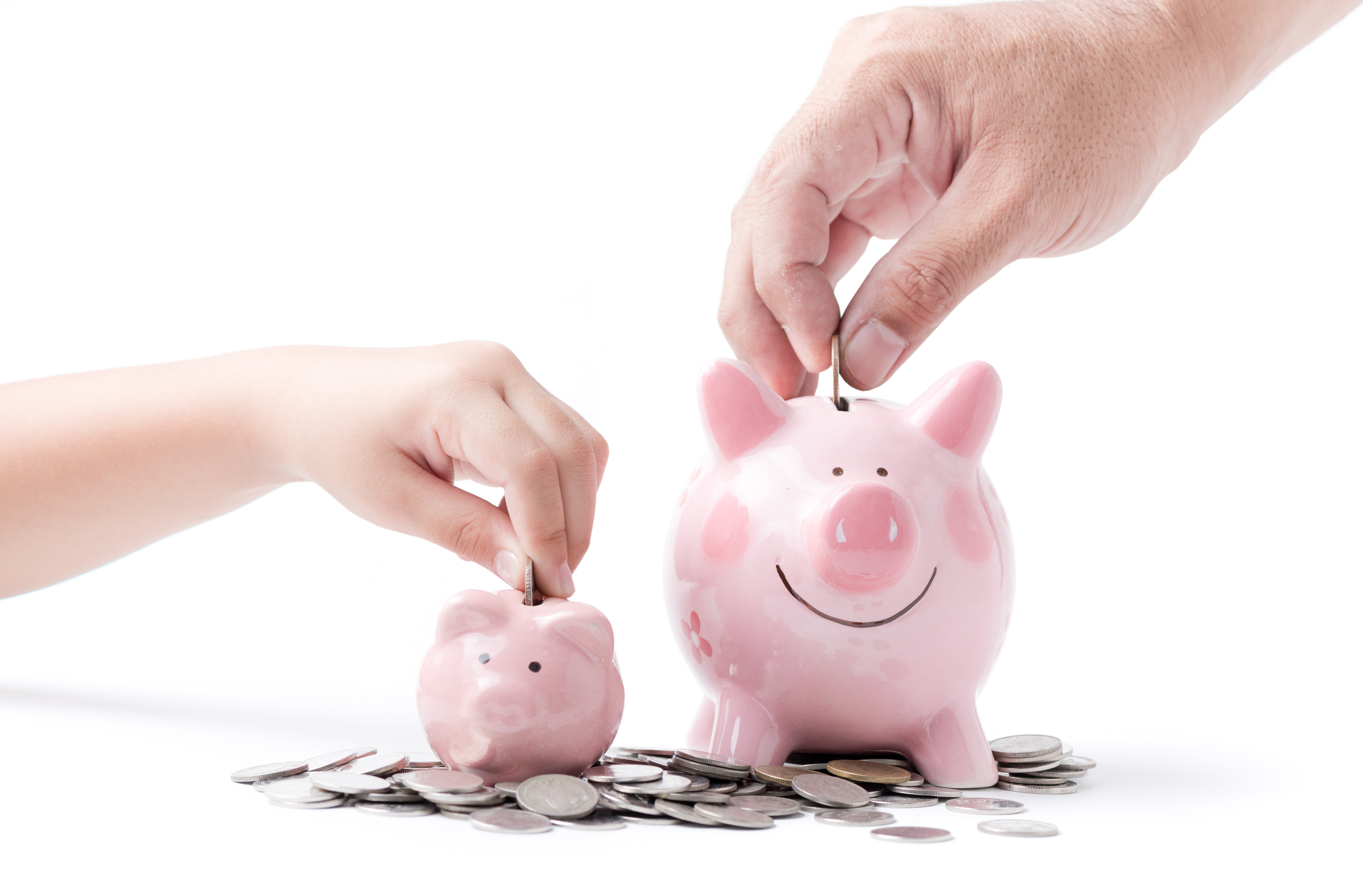 father and child hand put coin to piggy bank isolated on white background, saving money together concept